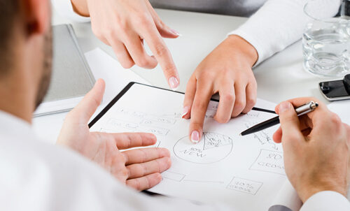 Womans hands pointing on the resources of new project